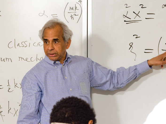 Professor Puru Jena stands in front of a whiteboard during a classroom lecture